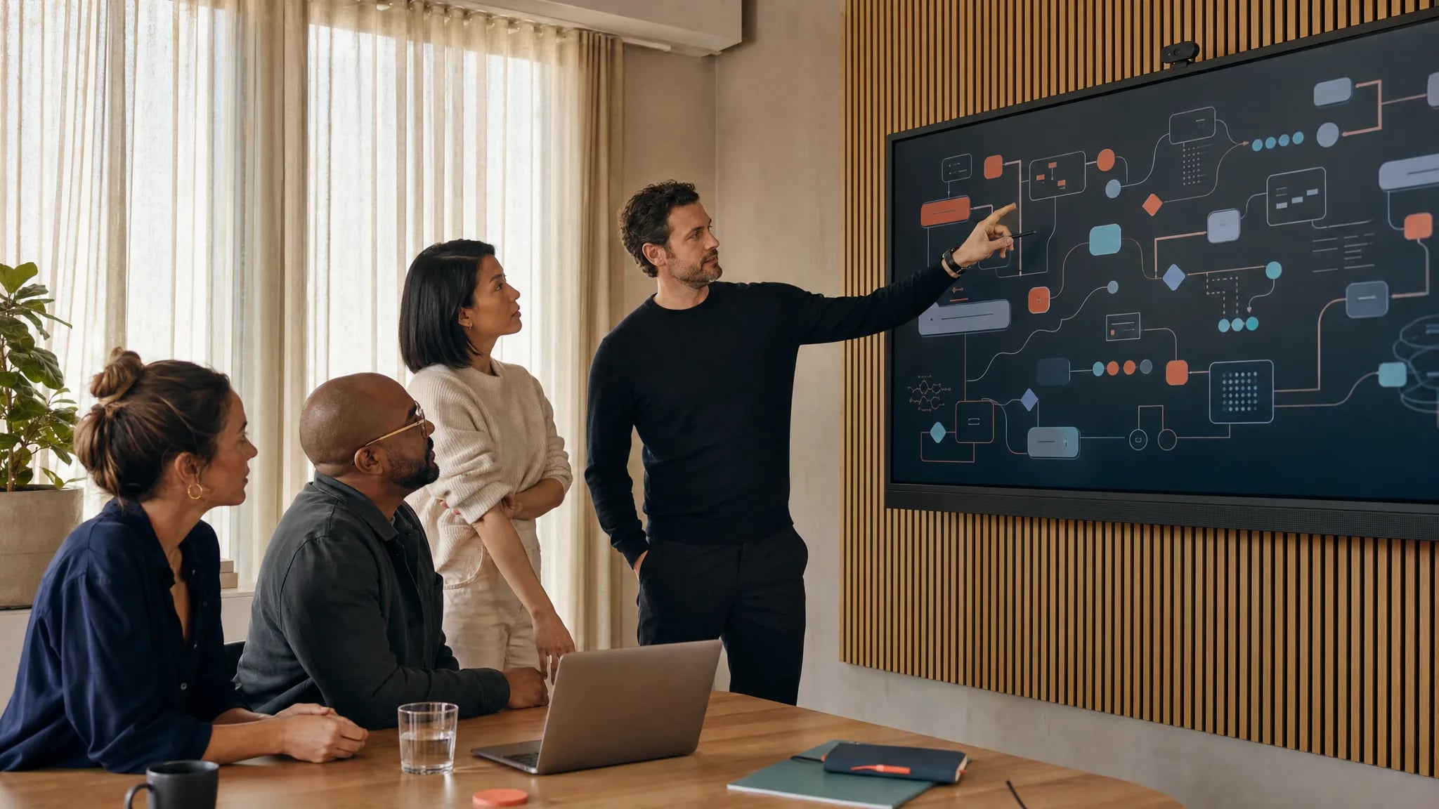A diverse consulting and enterprise team reviewing an AI-enabled workflow together.